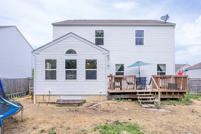447 Wingate Pl, Mount Sterling, OH 43143 - back of house with a trampoline, a deck, and fence
