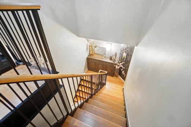 300 W Spring St Unit 515, Columbus, OH 43215 - staircase featuring wood finished floors, baseboards, and a high ceiling