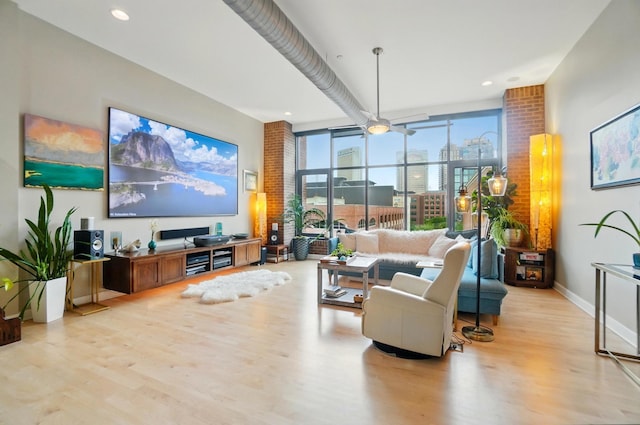 300 W Spring St Unit 515, Columbus, OH 43215 - living area featuring light wood-style floors, expansive windows, and baseboards