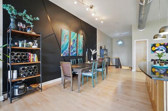 300 W Spring St Unit 515, Columbus, OH 43215 - dining space with light wood-style floors, baseboards, and rail lighting
