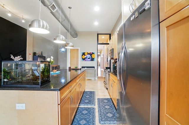 300 W Spring St Unit 515, Columbus, OH 43215 - kitchen featuring stainless steel appliances, dark stone counters, pendant lighting, and light wood-style flooring