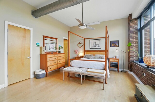 300 W Spring St Unit 515, Columbus, OH 43215 - bedroom featuring wood finished floors, baseboards, lofted ceiling, and a ceiling fan