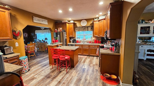 5353 Buckeye Valley Rd NE, New Lexington, OH 43764 - kitchen with freestanding refrigerator, a sink, a kitchen island, recessed lighting, and light countertops
