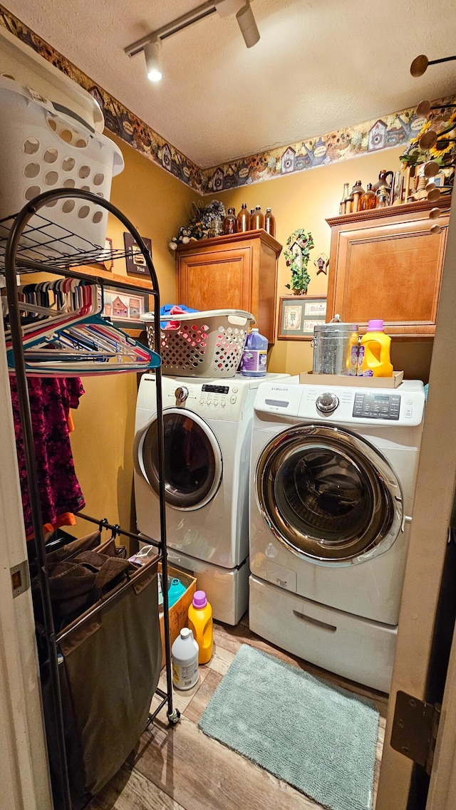 5353 Buckeye Valley Rd NE, New Lexington, OH 43764 - laundry room featuring cabinet space, separate washer and dryer, light wood-style floors, rail lighting, and a textured ceiling