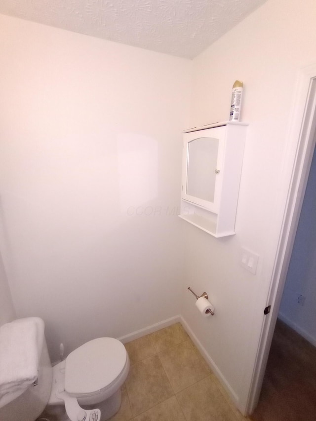 5888 Abernathy Ln Unit 5888A, Columbus, OH 43232 - bathroom featuring toilet, baseboards, and tile patterned flooring