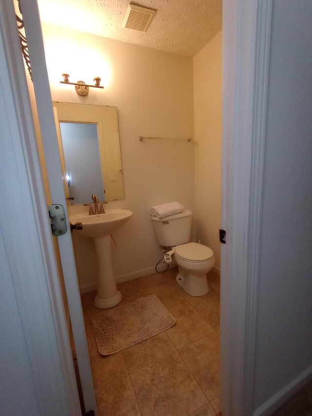 5888 Abernathy Ln Unit 5888A, Columbus, OH 43232 - bathroom with tile patterned flooring, toilet, a sink, and a textured ceiling