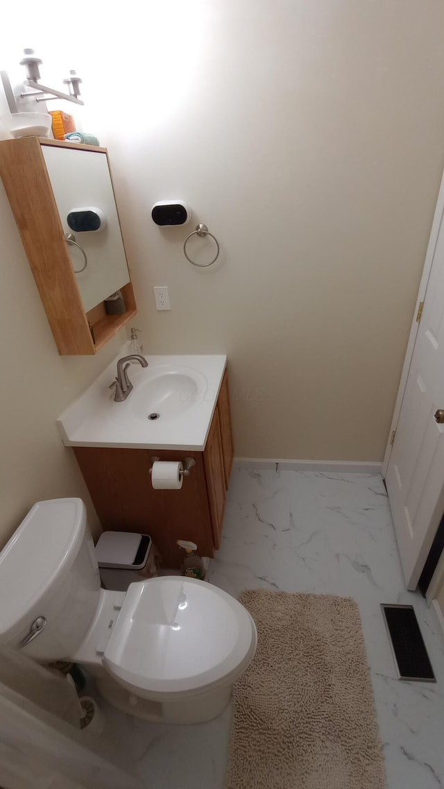5888 Abernathy Ln Unit 5888A, Columbus, OH 43232 - bathroom with toilet, vanity, marble finish floors, and baseboards