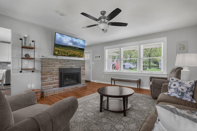 6641 Charles Rd, Westerville, OH 43082 - living room featuring wood finished floors, a ceiling fan, baseboards, and a fireplace with raised hearth