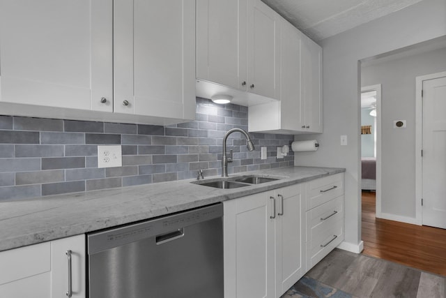 6641 Charles Rd, Westerville, OH 43082 - kitchen with dishwasher, a sink, white cabinetry, dark wood-type flooring, and light stone countertops