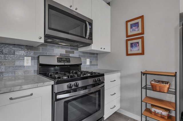 6641 Charles Rd, Westerville, OH 43082 - kitchen with appliances with stainless steel finishes, tasteful backsplash, and white cabinetry