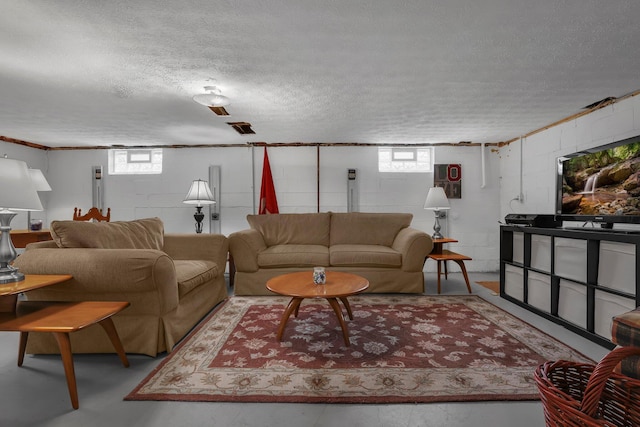 6641 Charles Rd, Westerville, OH 43082 - living room with concrete block wall, a textured ceiling, and concrete flooring
