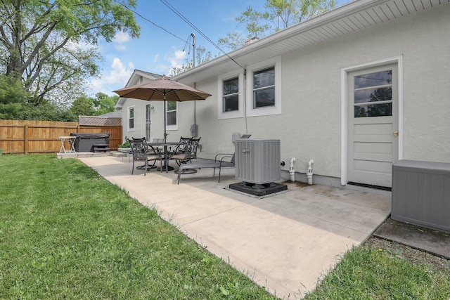 6641 Charles Rd, Westerville, OH 43082 - back of property featuring a hot tub, cooling unit, a patio area, and stucco siding