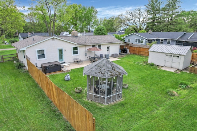 6641 Charles Rd, Westerville, OH 43082 - rear view of house featuring a shed, a covered hot tub, a patio area, an outdoor structure, and stucco siding
