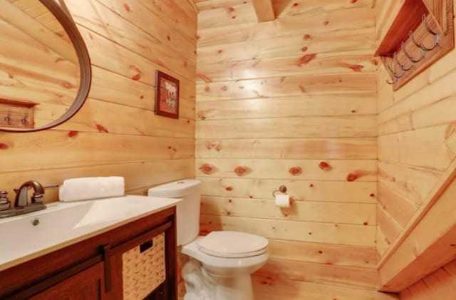 820 Pump Station Rd SE, Sugar Grove, OH 43155 - bathroom featuring wooden walls, toilet, and vanity