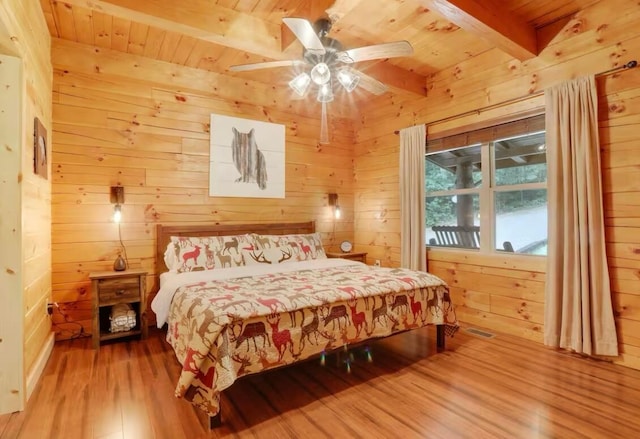 820 Pump Station Rd SE, Sugar Grove, OH 43155 - bedroom with beamed ceiling, wooden ceiling, light wood-type flooring, wooden walls, and ceiling fan