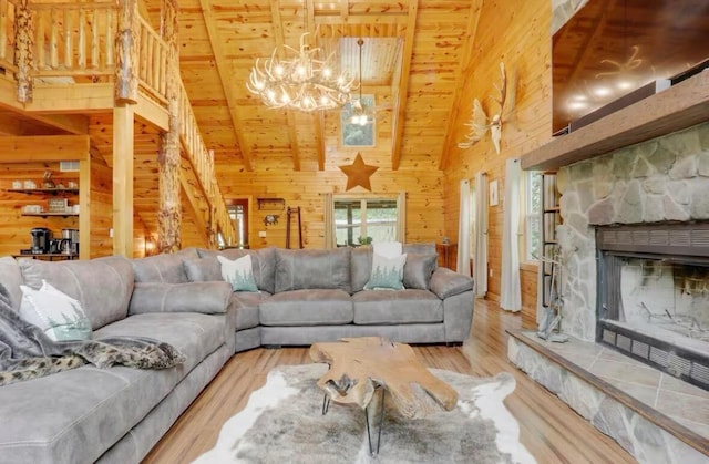 820 Pump Station Rd SE, Sugar Grove, OH 43155 - living room featuring wooden walls, wooden ceiling, a chandelier, wood finished floors, and high vaulted ceiling
