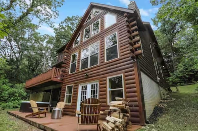 820 Pump Station Rd SE, Sugar Grove, OH 43155 - back of property with a chimney, log exterior, a deck, and a patio