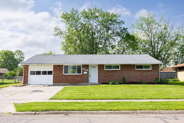 6729 Retton Rd, Reynoldsburg, OH 43068 - ranch-style home with an attached garage, driveway, and brick siding