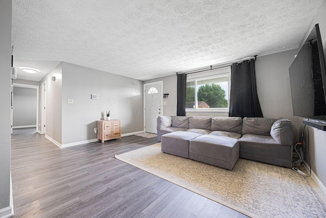 6729 Retton Rd, Reynoldsburg, OH 43068 - living room with wood finished floors, a textured ceiling, and baseboards