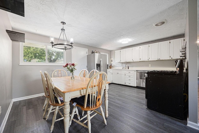 6729 Retton Rd, Reynoldsburg, OH 43068 - dining space featuring baseboards, a textured ceiling, dark wood-style flooring, and a chandelier