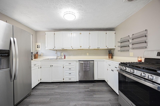 6729 Retton Rd, Reynoldsburg, OH 43068 - kitchen featuring stainless steel appliances, a sink, dark wood-type flooring, white cabinets, and a textured ceiling
