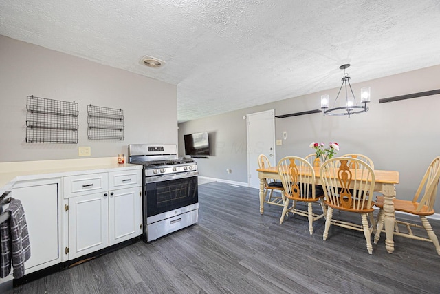 6729 Retton Rd, Reynoldsburg, OH 43068 - kitchen featuring stainless steel gas range oven, dark wood-type flooring, baseboards, a chandelier, and a textured ceiling