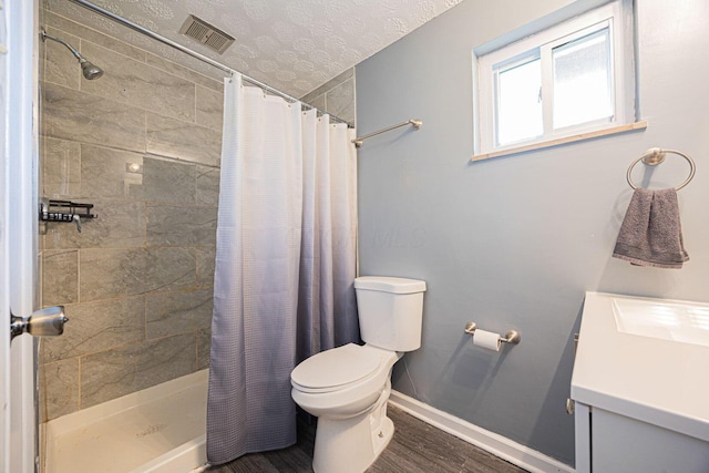 6729 Retton Rd, Reynoldsburg, OH 43068 - full bathroom featuring vanity, toilet, a stall shower, baseboards, and a textured ceiling