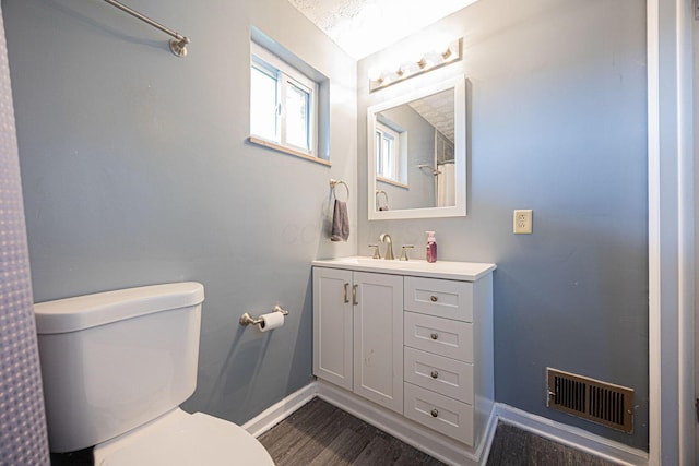 6729 Retton Rd, Reynoldsburg, OH 43068 - full bath featuring baseboards, toilet, wood finished floors, and vanity