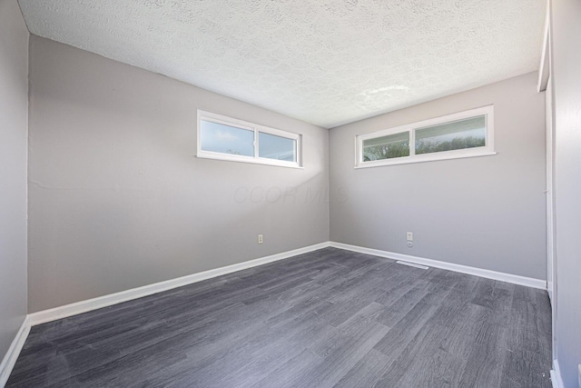 6729 Retton Rd, Reynoldsburg, OH 43068 - empty room featuring dark wood-style flooring, a textured ceiling, and baseboards