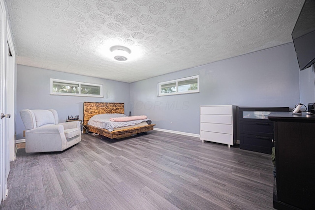 6729 Retton Rd, Reynoldsburg, OH 43068 - bedroom with wood finished floors, multiple windows, a textured ceiling, and baseboards