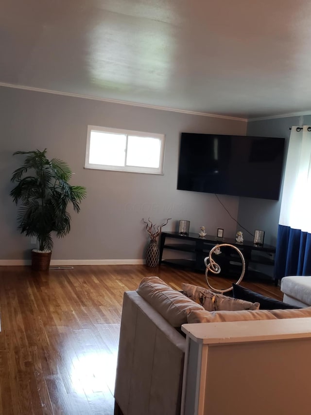 5060 Brinwood Pl, Columbus, OH 43232 - living area featuring ornamental molding, wood finished floors, and baseboards