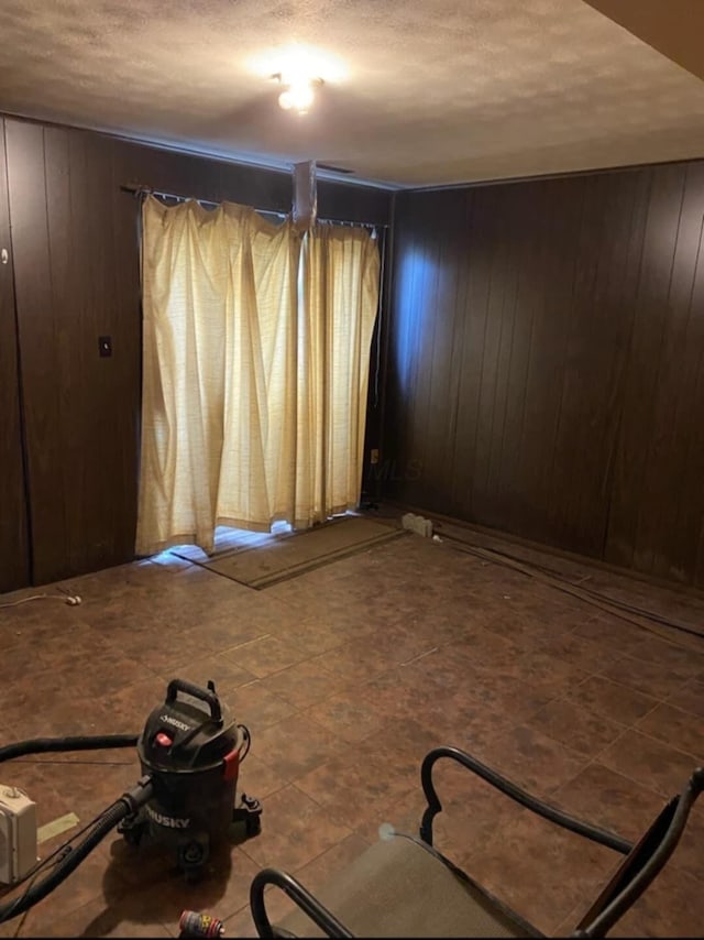 5060 Brinwood Pl, Columbus, OH 43232 - spare room with a textured ceiling and wood walls