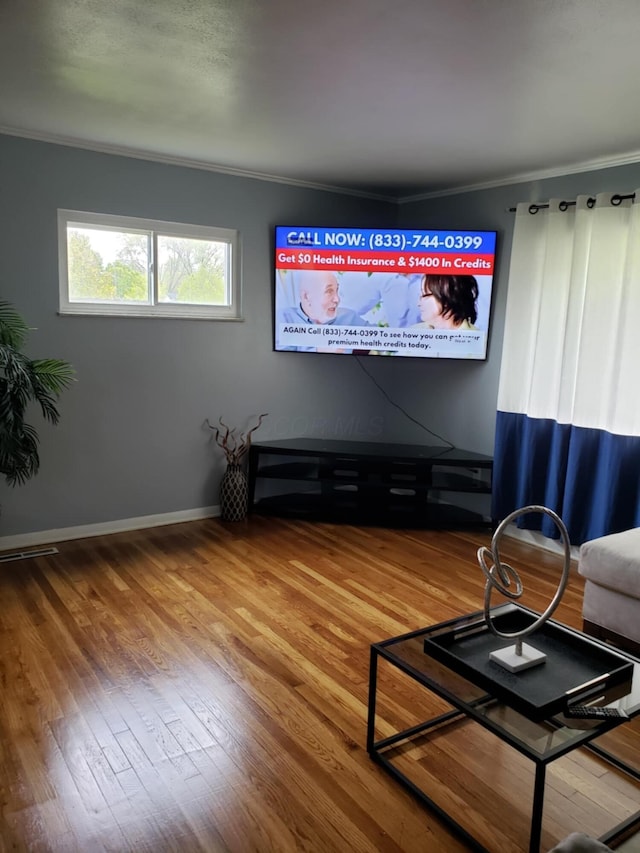 5060 Brinwood Pl, Columbus, OH 43232 - living room featuring crown molding, wood finished floors, and baseboards