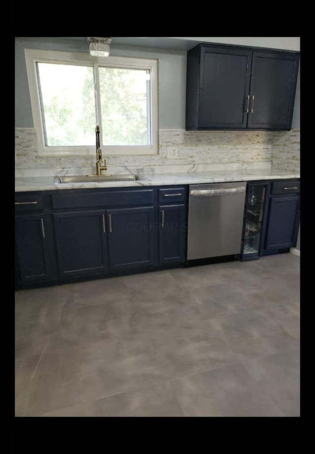 5060 Brinwood Pl, Columbus, OH 43232 - kitchen with stainless steel dishwasher, a sink, tasteful backsplash, and light countertops