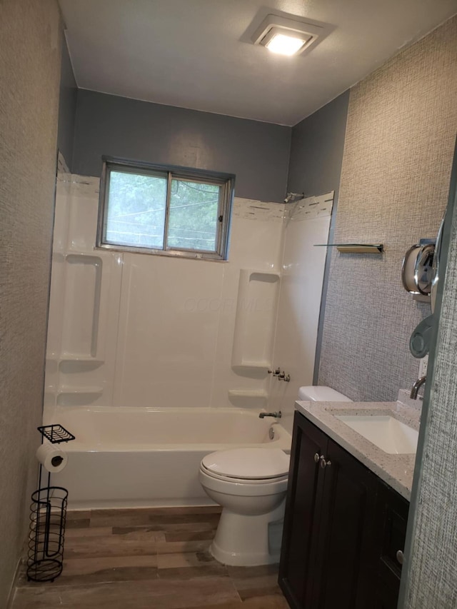 5060 Brinwood Pl, Columbus, OH 43232 - bathroom featuring wood finished floors, toilet, vanity, and washtub / shower combination