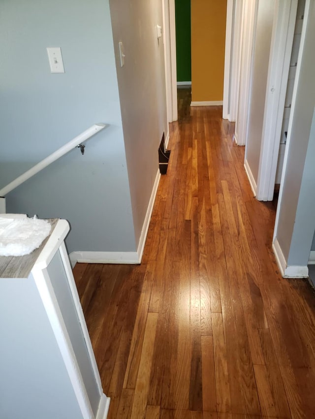 5060 Brinwood Pl, Columbus, OH 43232 - hall with hardwood / wood-style flooring, baseboards, and an upstairs landing