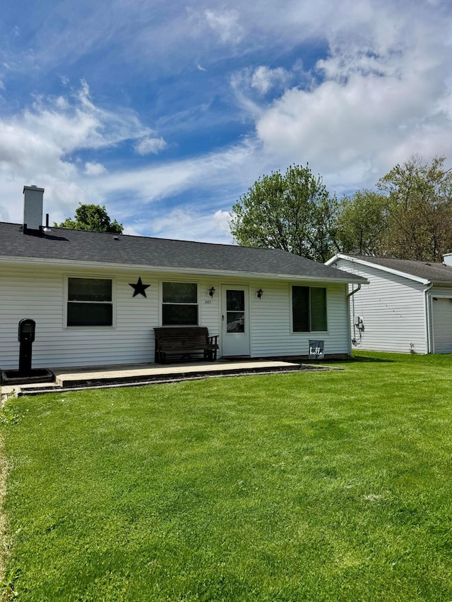 965 Bikini Dr, Marion, OH 43302 - back of house featuring a lawn, a patio area, and a garage