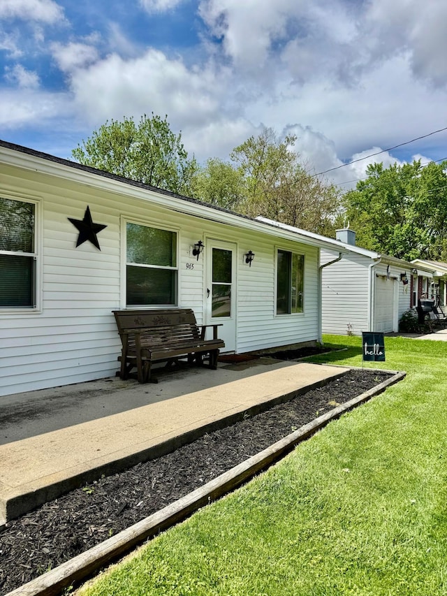 965 Bikini Dr, Marion, OH 43302 - back of house with a yard and an attached garage