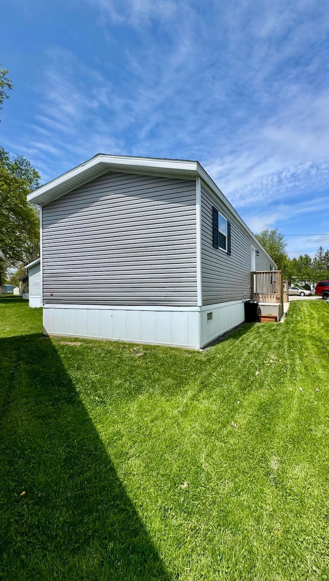 view of home's exterior with a lawn