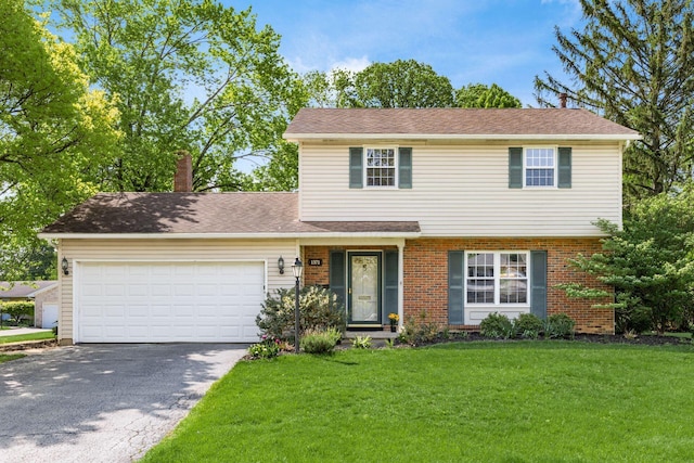 view of front of house with driveway, an attached garage, a front lawn, a chimney, and brick siding