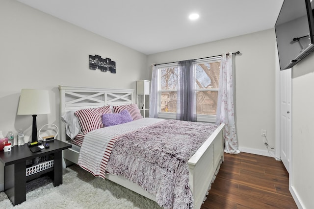 bedroom with wood finished floors, baseboards, and recessed lighting