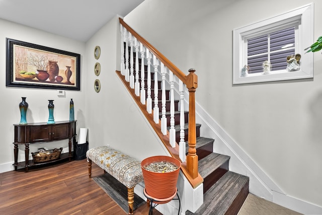 stairs featuring wood finished floors