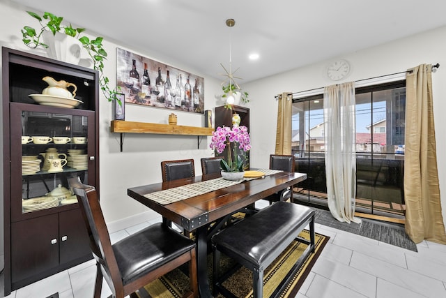 dining area with light tile patterned flooring, recessed lighting, and baseboards