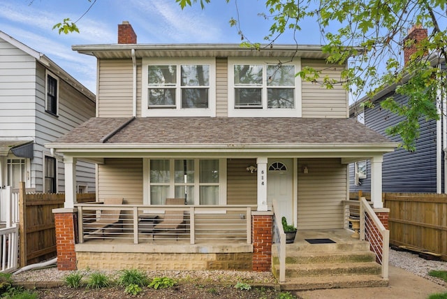 view of front of house with covered porch and fence