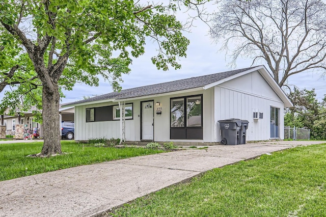 ranch-style house with a shingled roof and board and batten siding