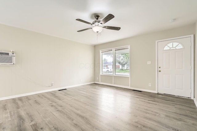 entryway with wood finished floors, ceiling fan, and baseboards