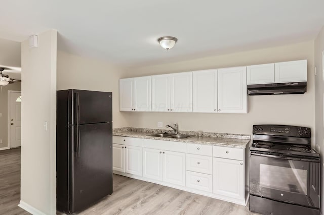 kitchen featuring black appliances, under cabinet range hood, a sink, and white cabinets