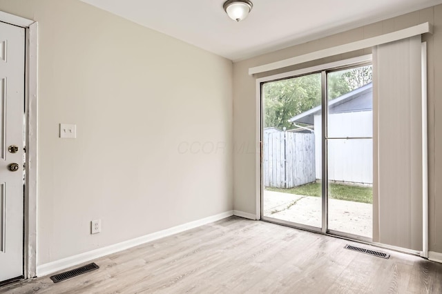 unfurnished room featuring light wood finished floors and baseboards