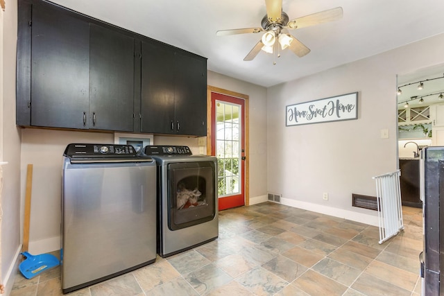 200 Park Ave, New Lexington, OH 43764 - laundry area with cabinet space, washer and dryer, baseboards, a ceiling fan, and light stone finish floors