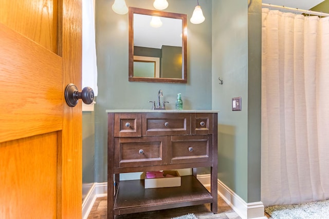 200 Park Ave, New Lexington, OH 43764 - full bathroom featuring baseboards, vanity, a shower with curtain, and wood finished floors